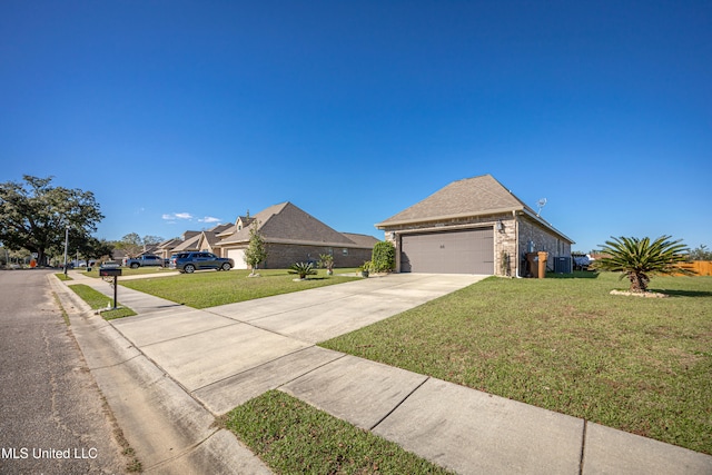 view of front of property featuring a front yard and a garage