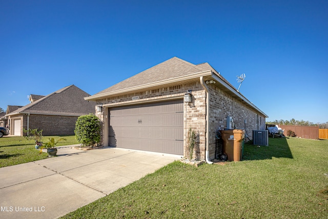 view of home's exterior featuring a yard, central AC unit, and a garage