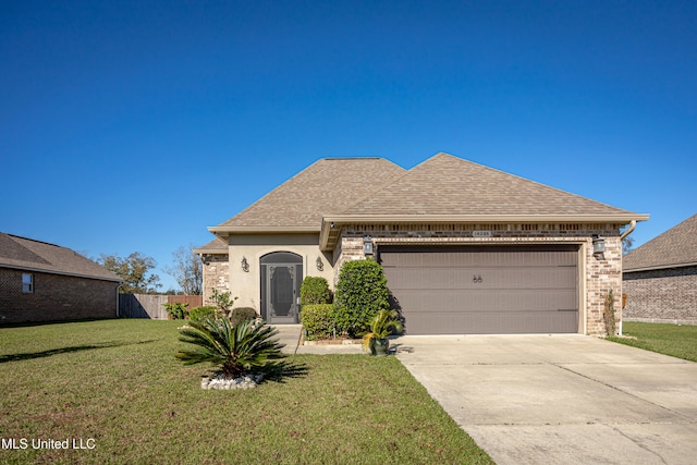 view of front of property featuring a garage and a front yard