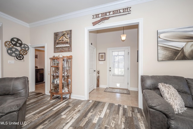 foyer entrance featuring hardwood / wood-style floors and ornamental molding