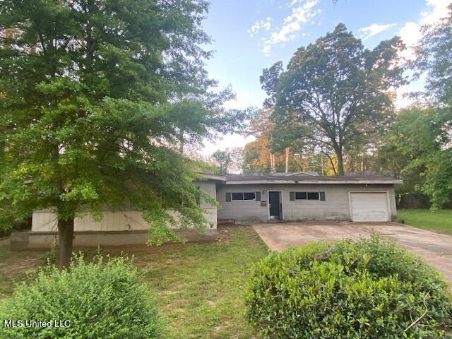 511 Forest Ave, Jackson, MS 39206 - view of front facade with concrete driveway and a garage
