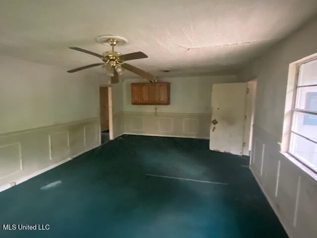 511 Forest Ave, Jackson, MS 39206 - empty room with a ceiling fan, wainscoting, and a decorative wall