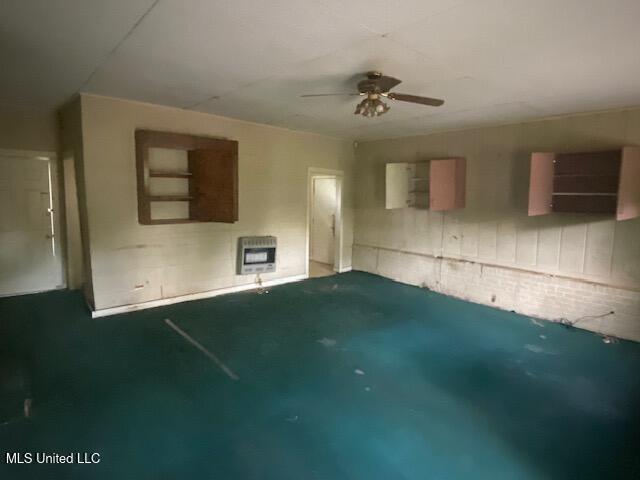 511 Forest Ave, Jackson, MS 39206 - unfurnished living room featuring heating unit and ceiling fan