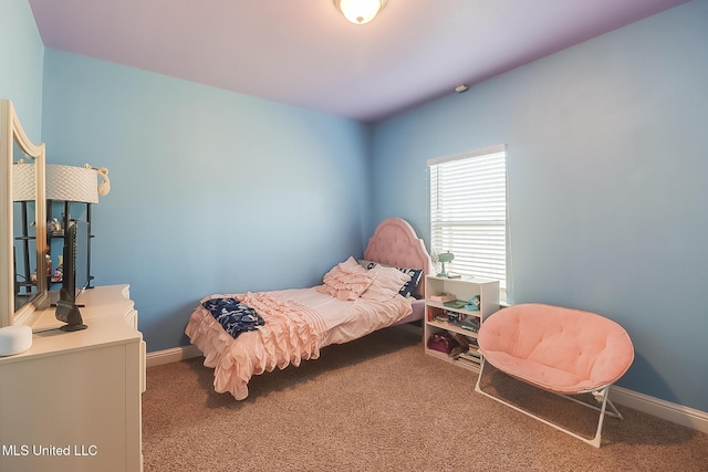 carpeted bedroom featuring baseboards