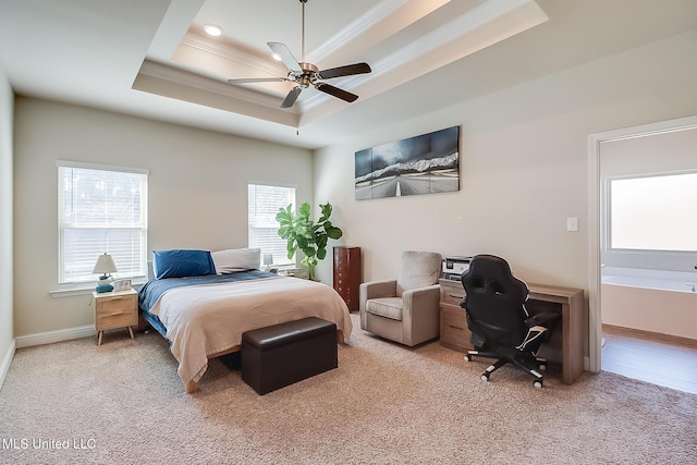 bedroom with ornamental molding, a raised ceiling, light colored carpet, and baseboards