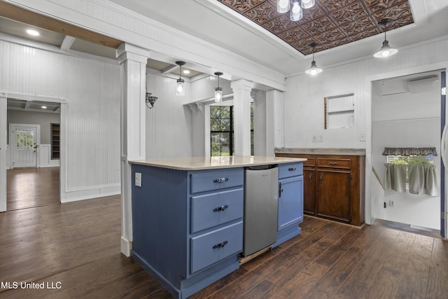 208 Washington Ave, Ocean Springs, MS 39564 - kitchen featuring blue cabinetry, ornate columns, dark wood-style floors, light countertops, and an ornate ceiling