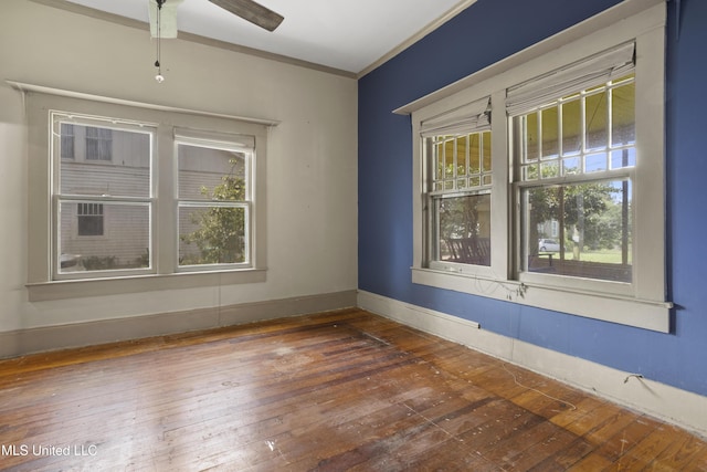 208 Washington Ave, Ocean Springs, MS 39564 - empty room with hardwood / wood-style floors, baseboards, a ceiling fan, and crown molding