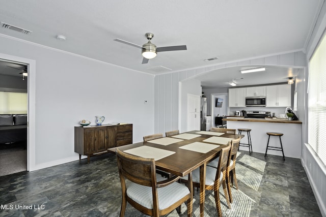 dining room with crown molding, plenty of natural light, and ceiling fan