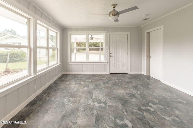 unfurnished sunroom with a wealth of natural light and ceiling fan