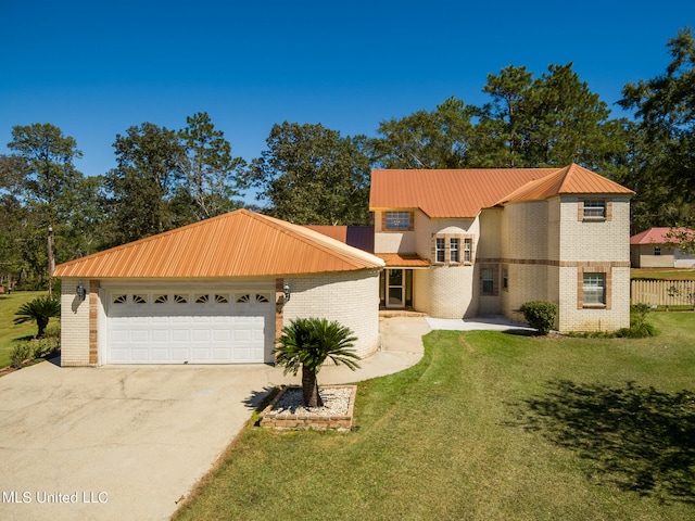 view of front of property with a front yard and a garage