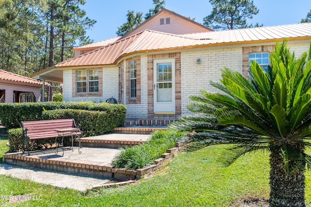 back of house featuring a patio and a yard