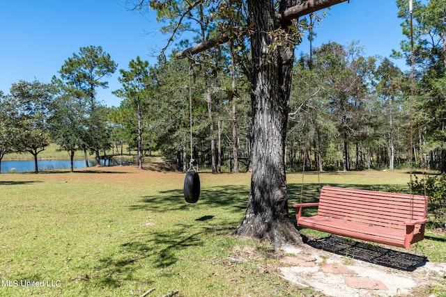 view of community with a water view and a lawn