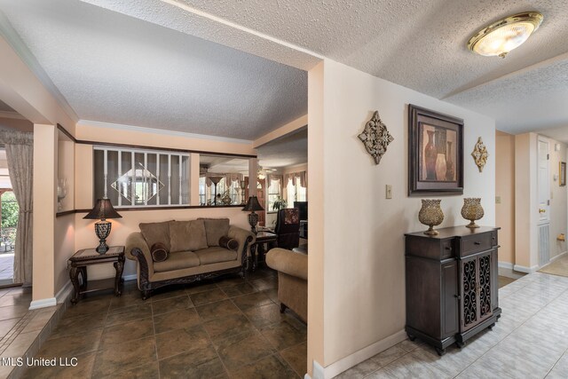 corridor with crown molding and a textured ceiling