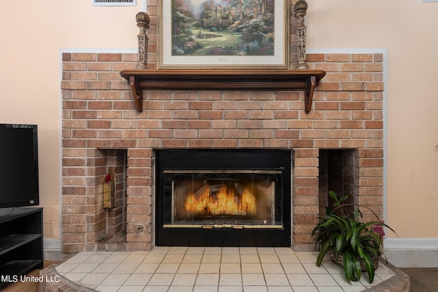 details featuring tile patterned floors and a brick fireplace