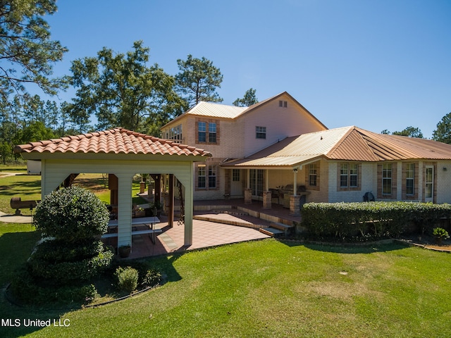 back of property featuring a gazebo, a patio area, and a yard