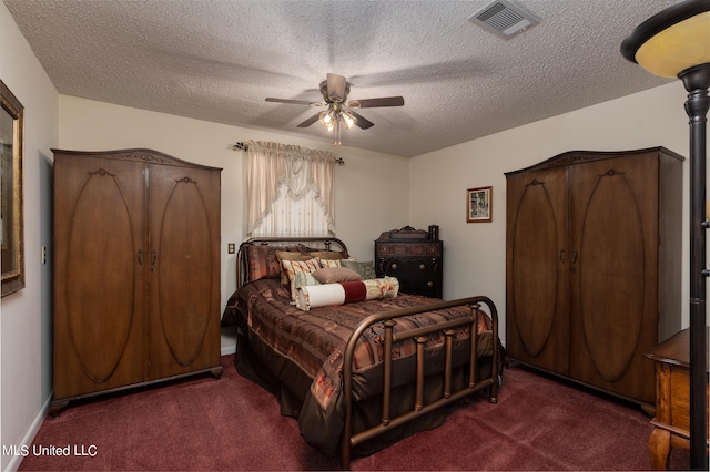 carpeted bedroom featuring a textured ceiling and ceiling fan