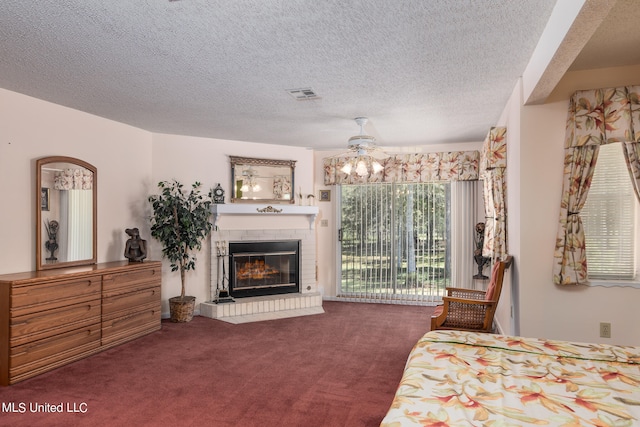 carpeted bedroom featuring a textured ceiling, a brick fireplace, access to exterior, and ceiling fan