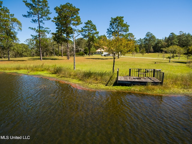 view of home's community featuring a yard and a water view