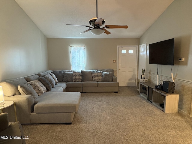 carpeted living room featuring ceiling fan and lofted ceiling