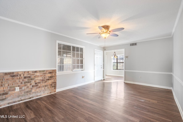 spare room featuring crown molding, dark hardwood / wood-style floors, a textured ceiling, and ceiling fan