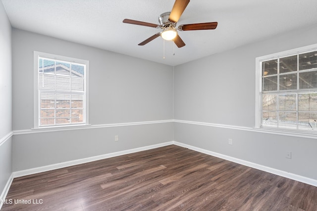 unfurnished room with a healthy amount of sunlight, dark wood-type flooring, a textured ceiling, and ceiling fan