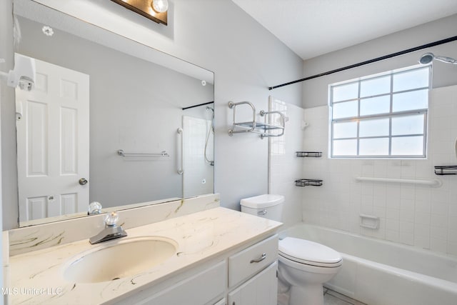 full bathroom with vanity, tiled shower / bath, and toilet