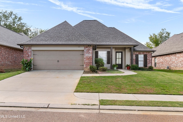 view of front of property featuring a garage and a front yard