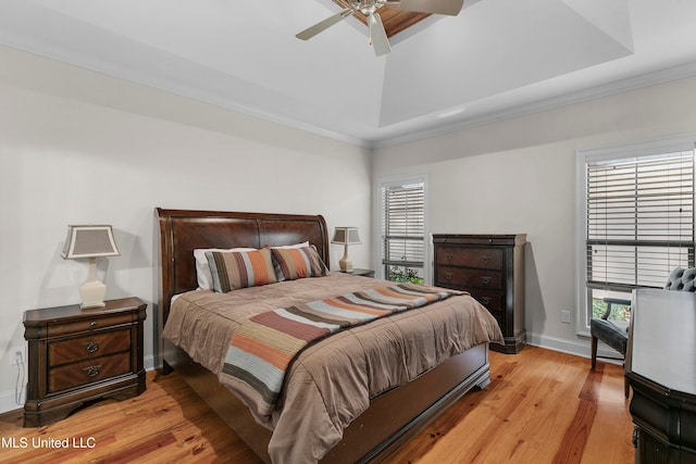 bedroom with multiple windows, ceiling fan, light hardwood / wood-style flooring, and crown molding