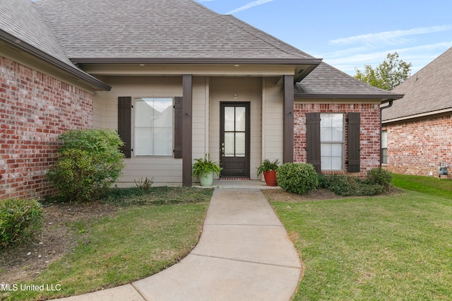 entrance to property with a lawn