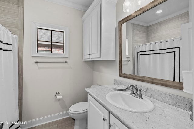 bathroom with curtained shower, hardwood / wood-style floors, toilet, vanity, and ornamental molding