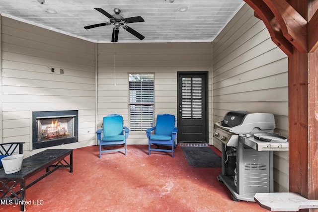 view of patio with ceiling fan, a grill, and a fireplace