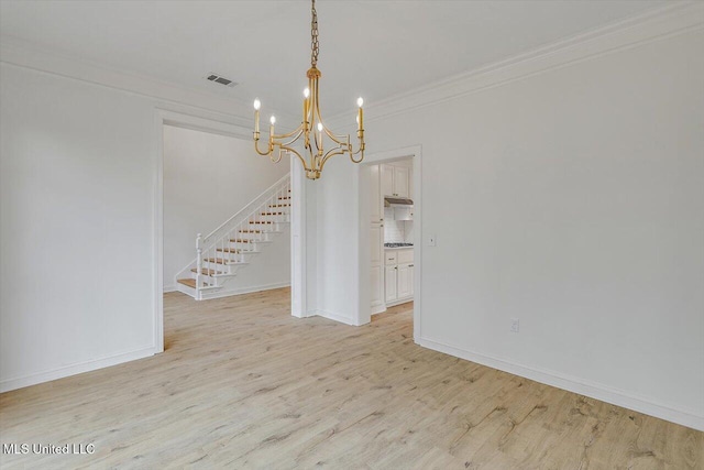 interior space with ornamental molding, a notable chandelier, and light wood-type flooring