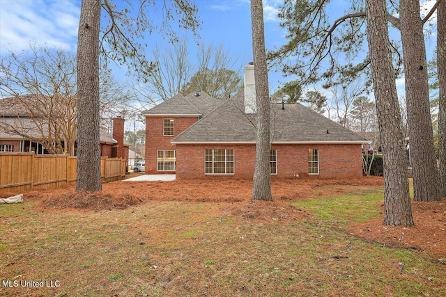 rear view of property featuring a yard and a patio area