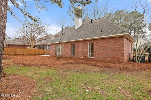 back of house with a lawn