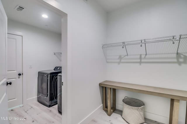 washroom featuring light hardwood / wood-style flooring and washer and dryer