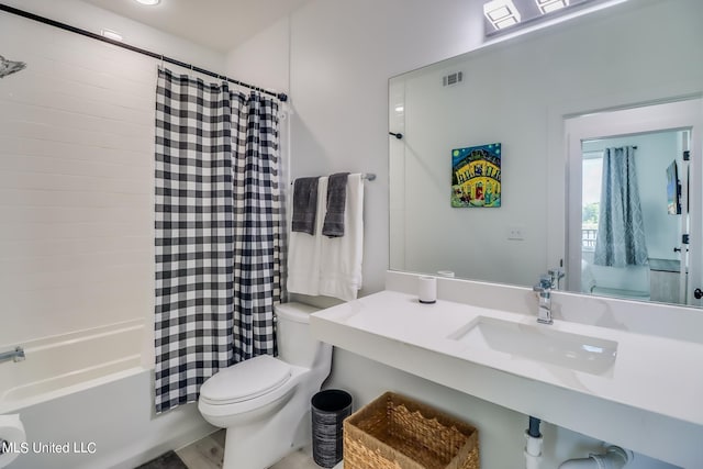 full bathroom featuring shower / bath combination with curtain, toilet, hardwood / wood-style flooring, and sink