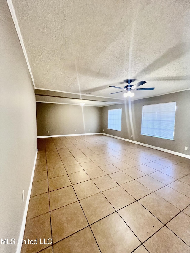 empty room with light tile patterned floors, a textured ceiling, and ceiling fan