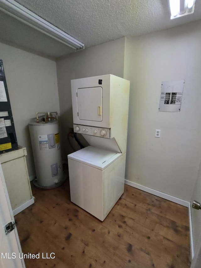 laundry area featuring a textured ceiling, electric water heater, stacked washing maching and dryer, and dark hardwood / wood-style floors