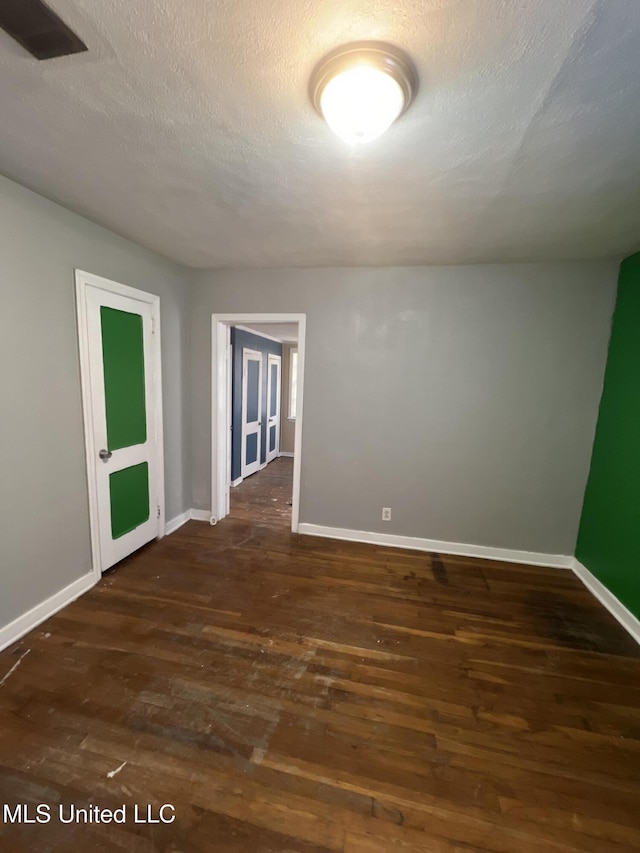 3258 Meadow Ln, Jackson, MS 39212 - spare room with dark wood-type flooring and a textured ceiling