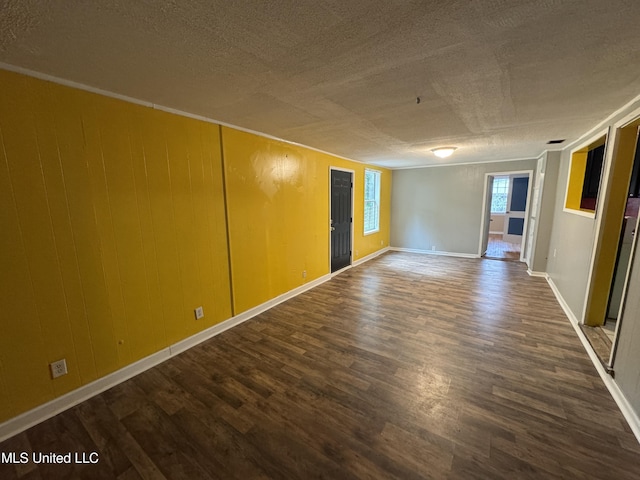 3258 Meadow Ln, Jackson, MS 39212 - spare room featuring a textured ceiling and dark wood-style flooring