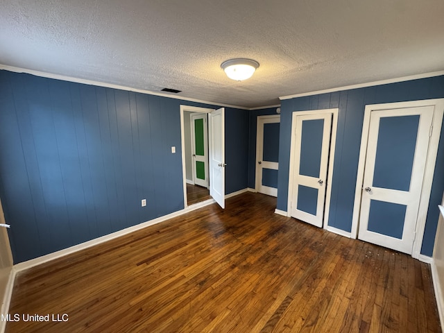 3258 Meadow Ln, Jackson, MS 39212 - unfurnished bedroom with wood finished floors, a textured ceiling, and crown molding