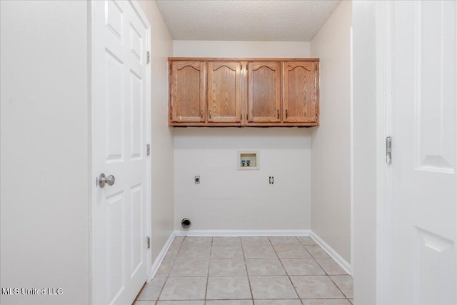 7488 Hickory Estates Dr, Walls, MS 38680 - washroom with electric dryer hookup, a textured ceiling, cabinet space, light tile patterned floors, and hookup for a washing machine