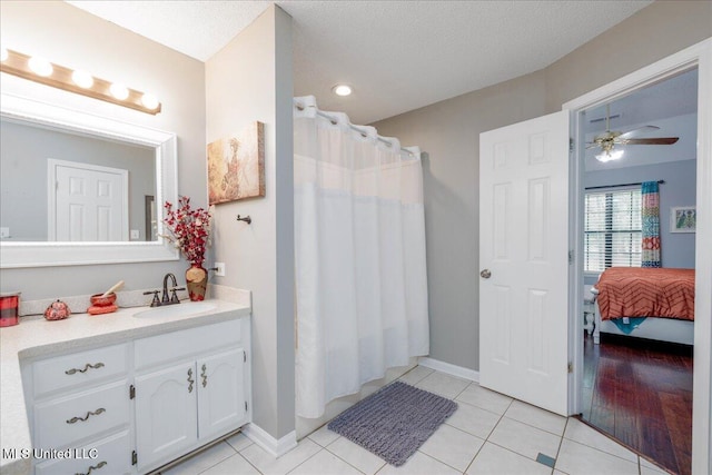 7488 Hickory Estates Dr, Walls, MS 38680 - bathroom with tile patterned flooring, ceiling fan, baseboards, and vanity