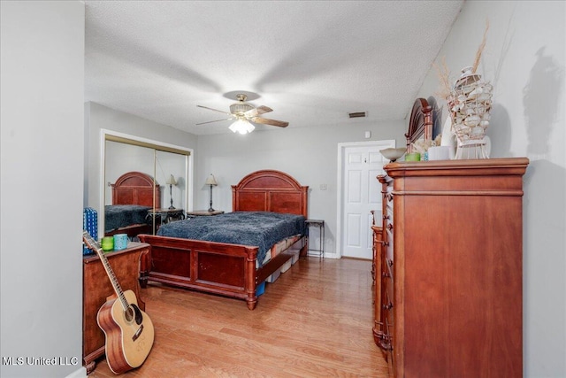 7488 Hickory Estates Dr, Walls, MS 38680 - bedroom with ceiling fan, a textured ceiling, visible vents, a closet, and light wood-style flooring