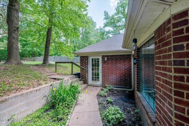 7488 Hickory Estates Dr, Walls, MS 38680 - view of home's exterior with brick siding, roof with shingles, and fence