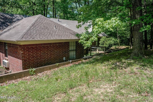 7488 Hickory Estates Dr, Walls, MS 38680 - view of side of home with roof with shingles, a chimney, and brick siding