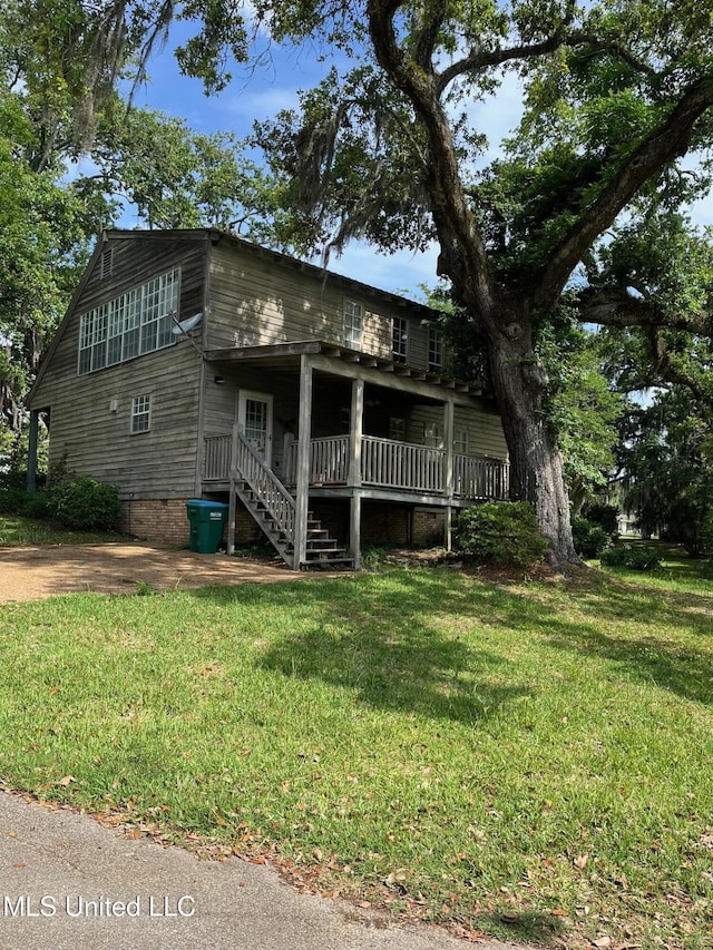view of front of property with a front lawn and stairway