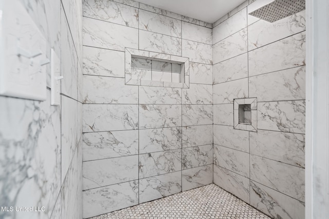 bathroom with tiled shower