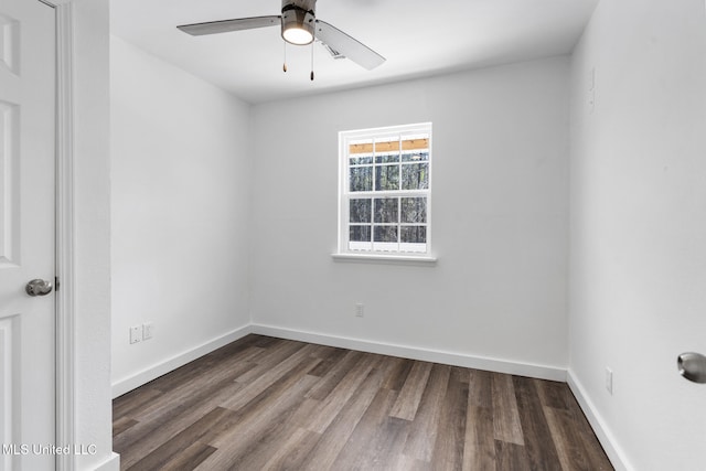 empty room with a ceiling fan, baseboards, and wood finished floors