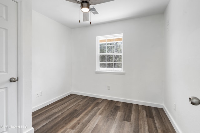 unfurnished room featuring visible vents, dark wood finished floors, baseboards, and ceiling fan